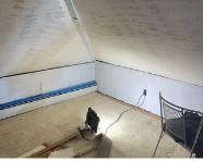 Attic before — exposed insulation and framing