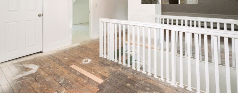 Attic transformation — restored hallway, railing, and wood floor