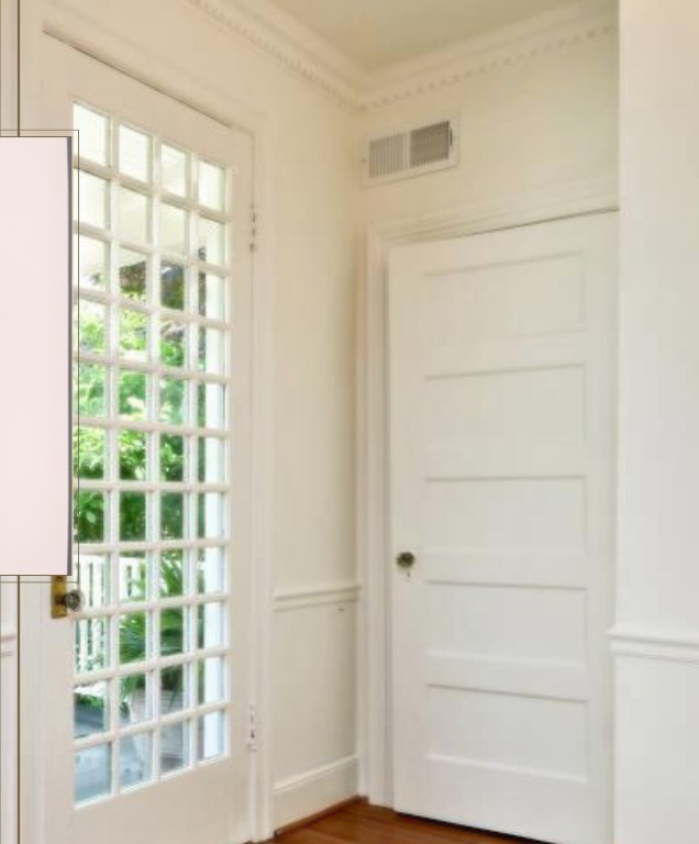 Restored entry hallway with original wood door