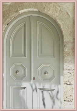 Restored entry door, arched stone surround
